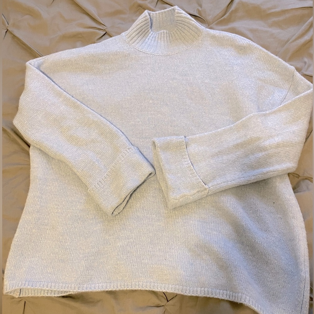 Loose fitting, blue turtleneck sweater